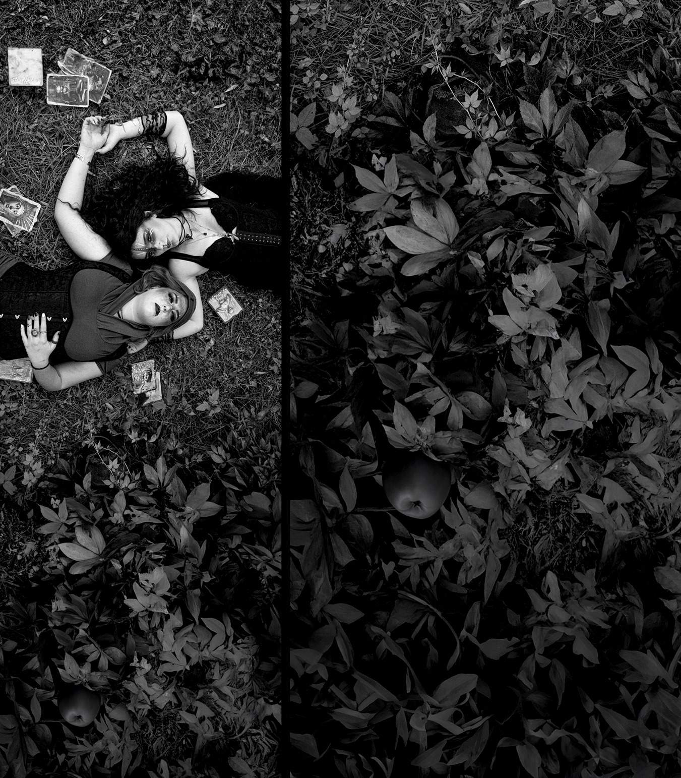 Black and white photograph of two women lying on the grass with tarot cards, photographed by Mark Shaun Hopkins.
