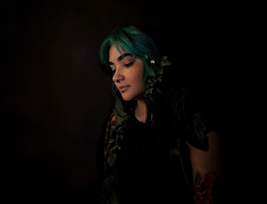 Portrait of a woman with blue hair and plant vines, photographed by Mark Shaun Hopkins.